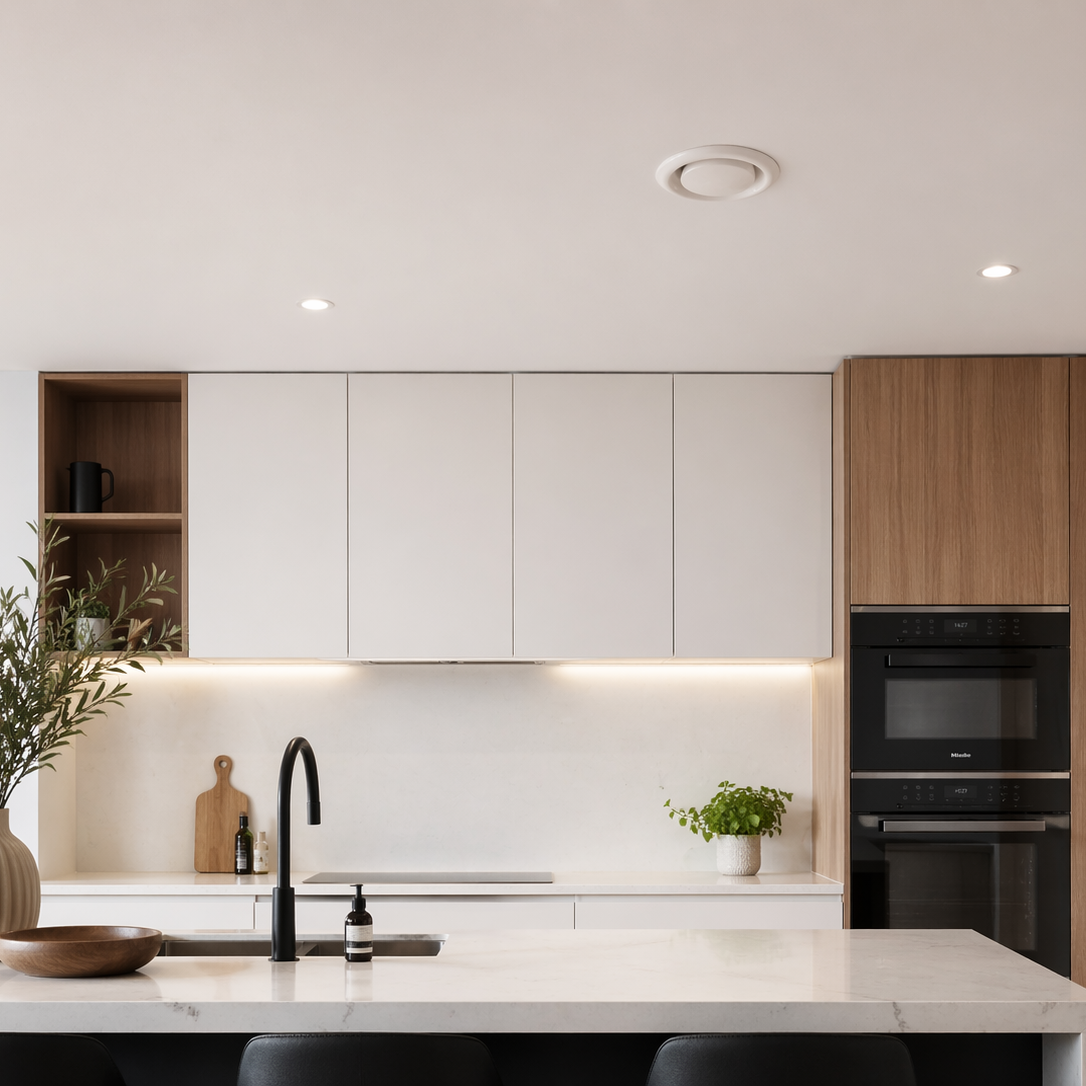 Modern kitchen with white cabinets, black appliances, and a white countertop.